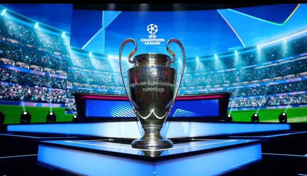 UEFA Champions League trophy displayed on a illuminated stage